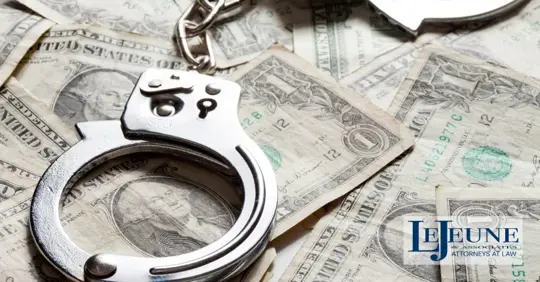 handcuffs and dollar bills